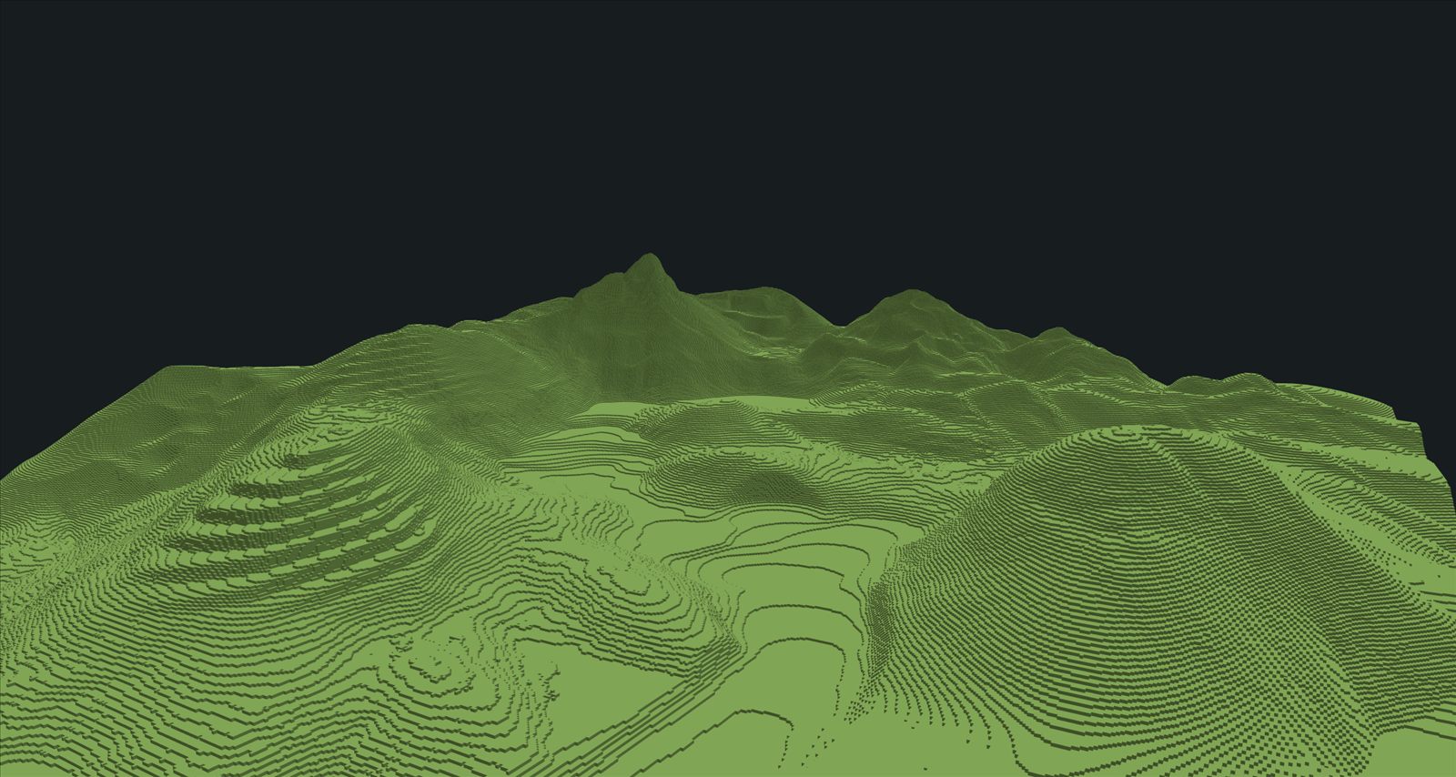 Freshly sculpted voxel terrain: green terraced hills rising to a jagged mountain ridge.